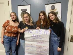 Students Pose with a poster