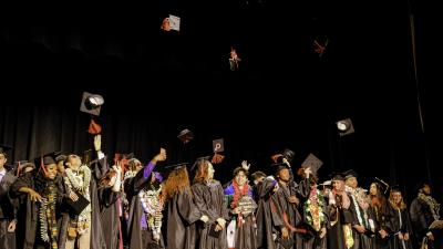 graduates throw hats