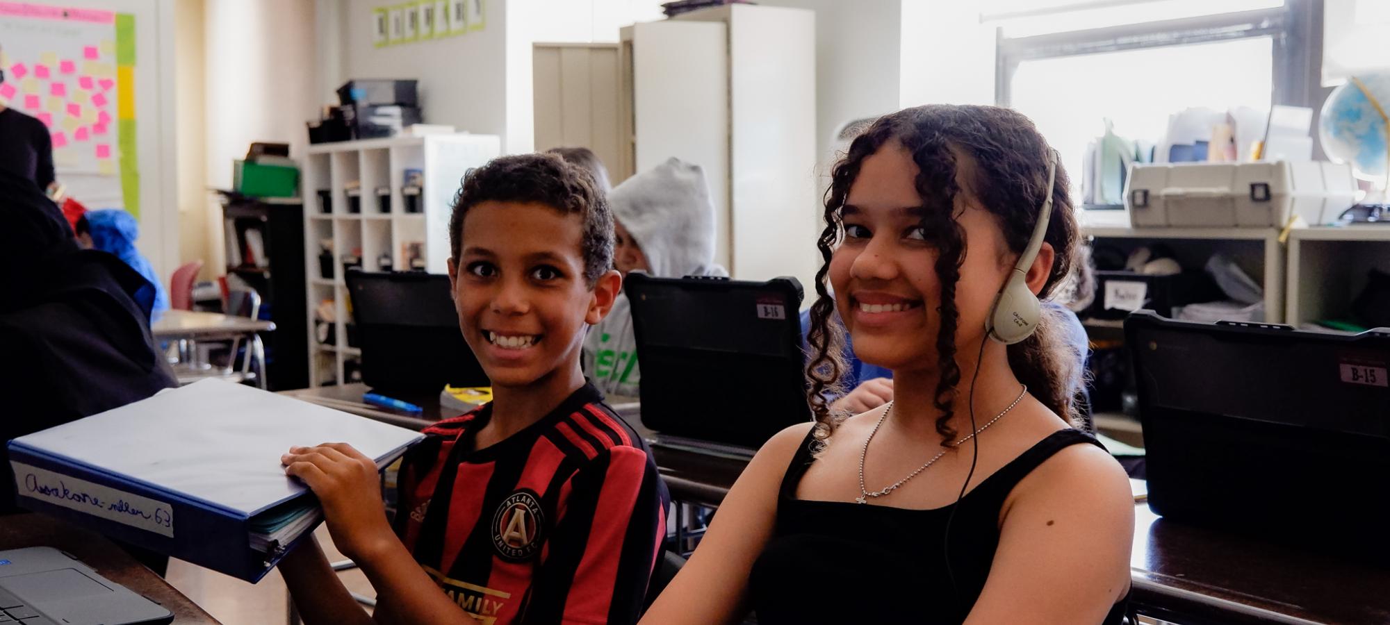 two students smile for camera